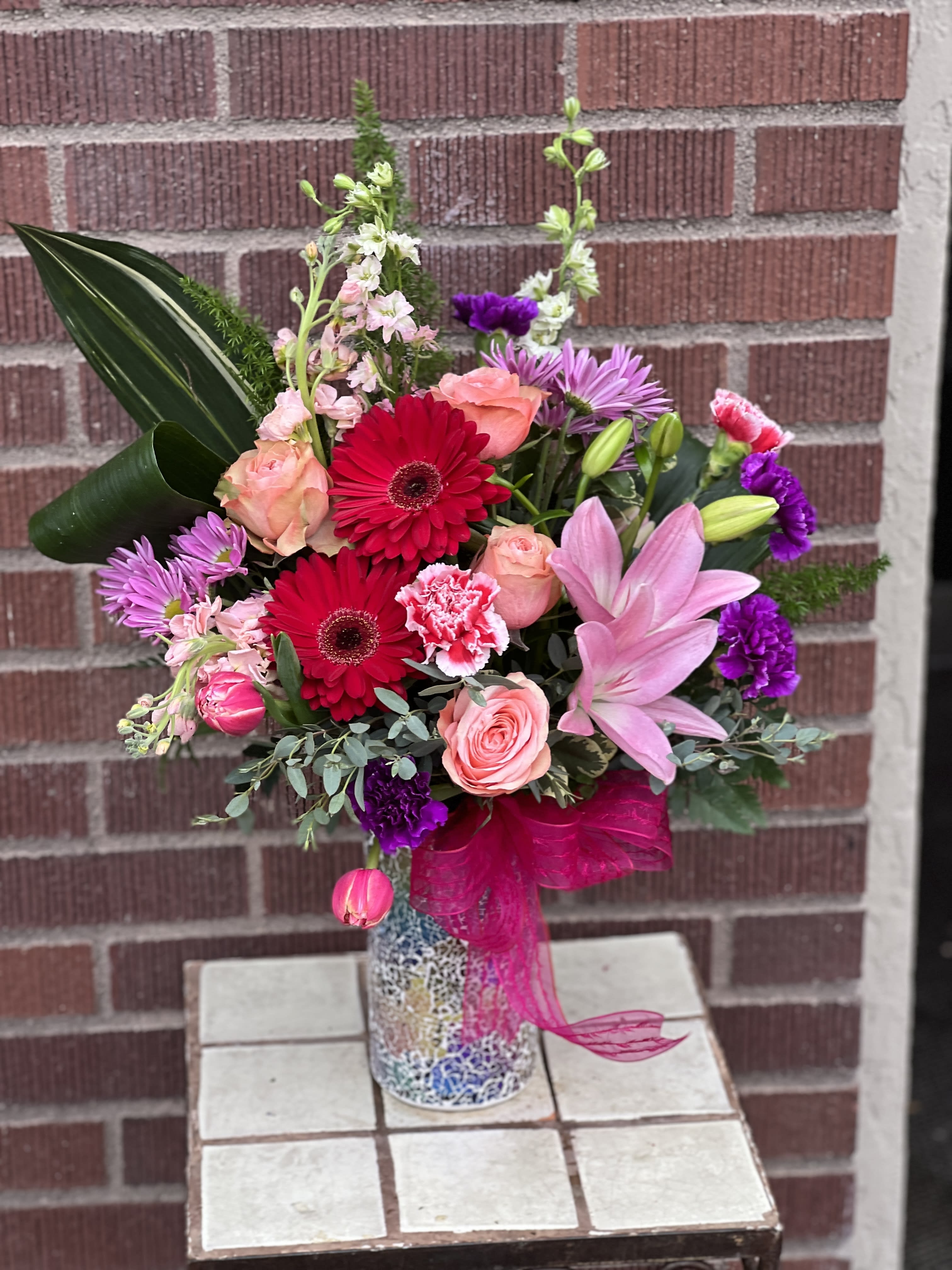 Everything Nice - Designed by one of our local gals, and arriving in a keepsake Teleflora mosaic container, shade of flowers may vary, but will be in the pink/lavendar/red/peach color scheme.