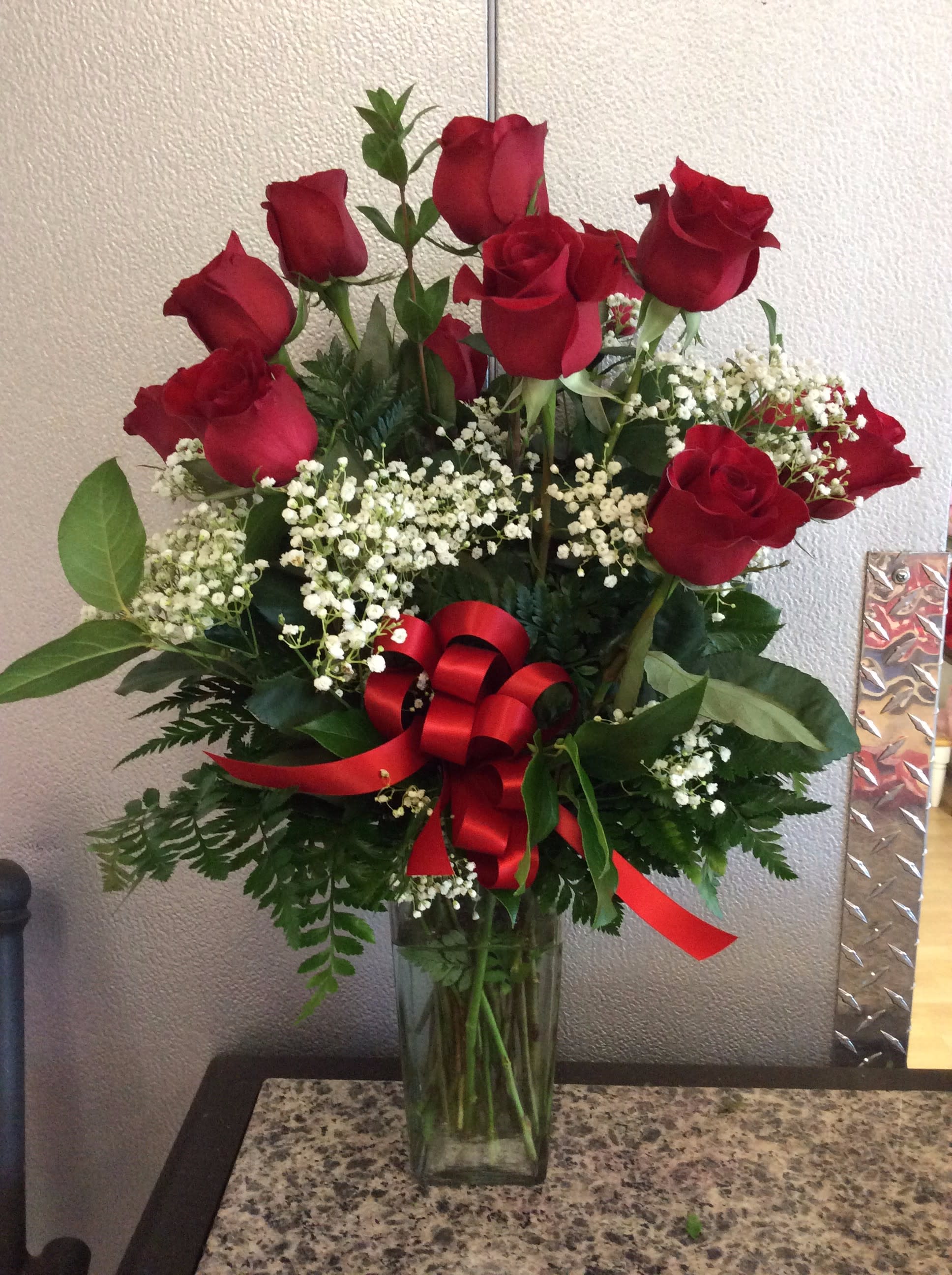 Dz. Red Roses w/ Babies Breath - 12 Red Roses arranged in glass vase w/ filler &amp; greens - Approx. Height 19&quot;