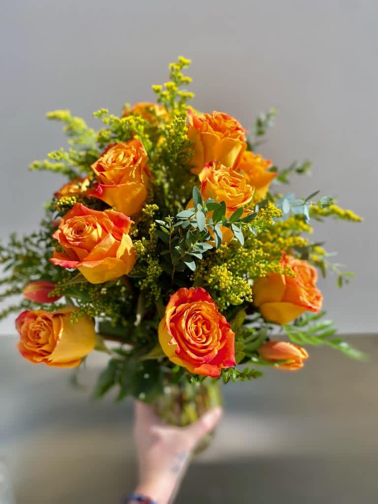 Mimosa Roses - Every day is worthy of a mimosa! A dozen golden yellow roses with yellow accent flowers. Just to let you know, flowers and vases may vary but we do our best to match the arrangement shown.  