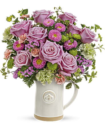 Teleflora's Artisanal Pitcher Bouquet - Pour on the happiness! Mother's Day feels extra special when a beautiful rose bouquet is delivered in this artisanal glazed stoneware pitcher with charming sculpted bee detail. Food safe, it's sure to be a kitchen favorite for many years to come! This perky bouquet includes pink roses, green carnations, miniature peach carnations, pink matsumoto asters, green button spray chrysanthemums, pink sinuata statice, bupleurum, pitta negra and leatherleaf fern. This Mother's Day arrangement is delivered in Teleflora's Artisanal Pitcher.. Orientation: All-Around