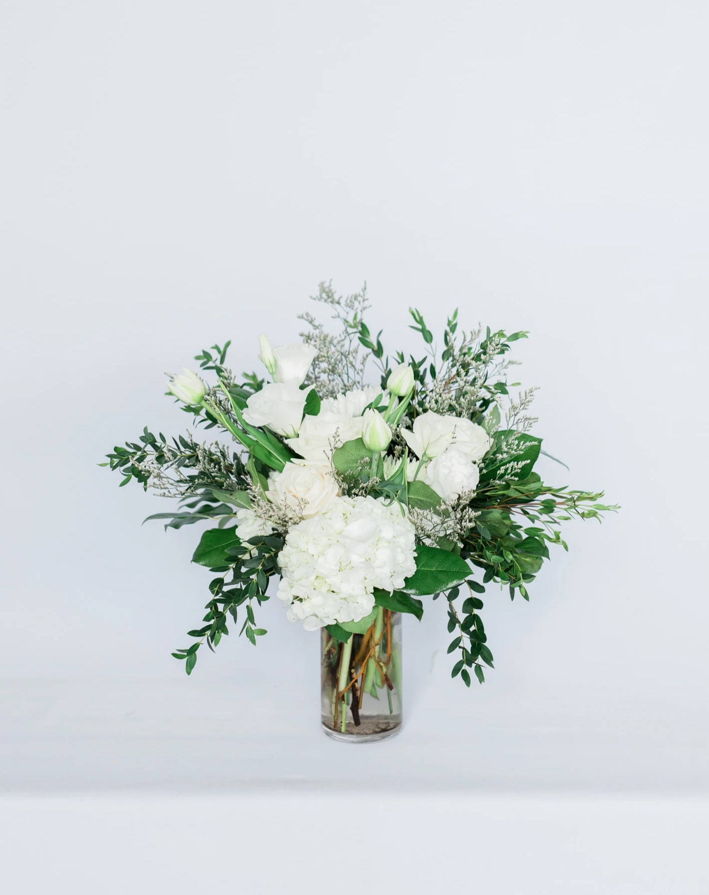 Ivory Memory - Beautiful mix of whites, greens and creams arranged in a low cylinder glass vase.  pictured [DELUXE]