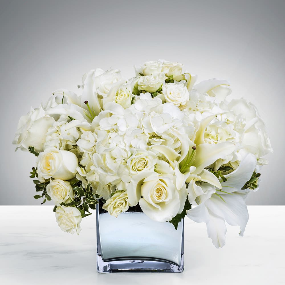 Pure Beauty - White is always a classic color for any occasion. This will put a smile on the face of anyone!  A lovely collection of soft white flowers in a beautiful cube makes the perfect coffee table or a dining room table.