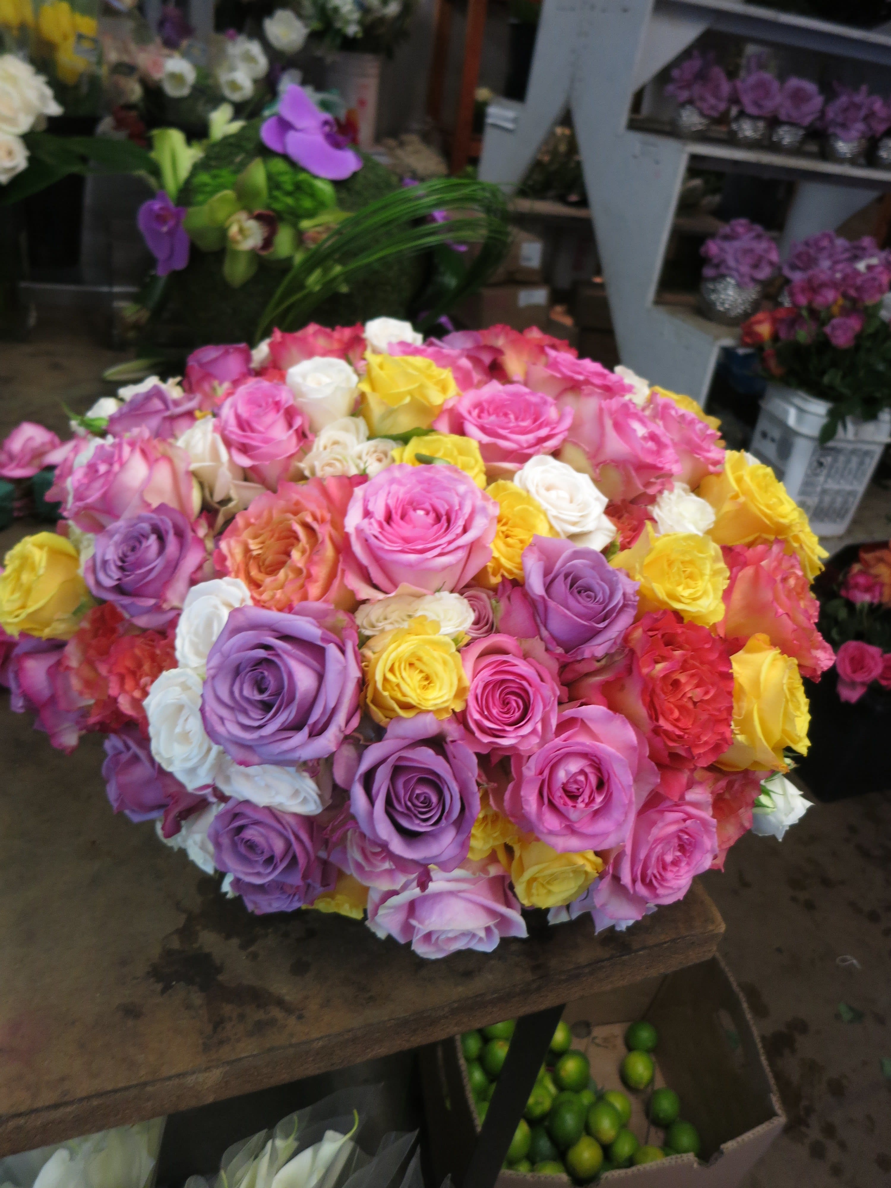 Rainbow Sherbet Roses - A Blast of All different color roses Arranged in Oasis Dish.
