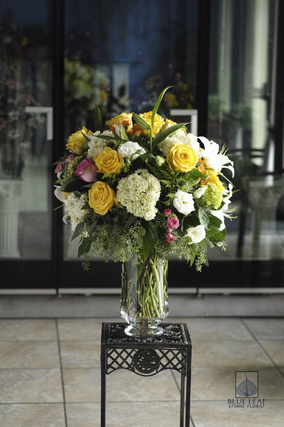 Paramount Garden Bright - Similar to our Paramount Garden bouquet, but brightened with yellow roses and vivid pinks. Flowers include fluffy white hydrangeas, roses, lilies and alstromeria in a large elegant vase. 