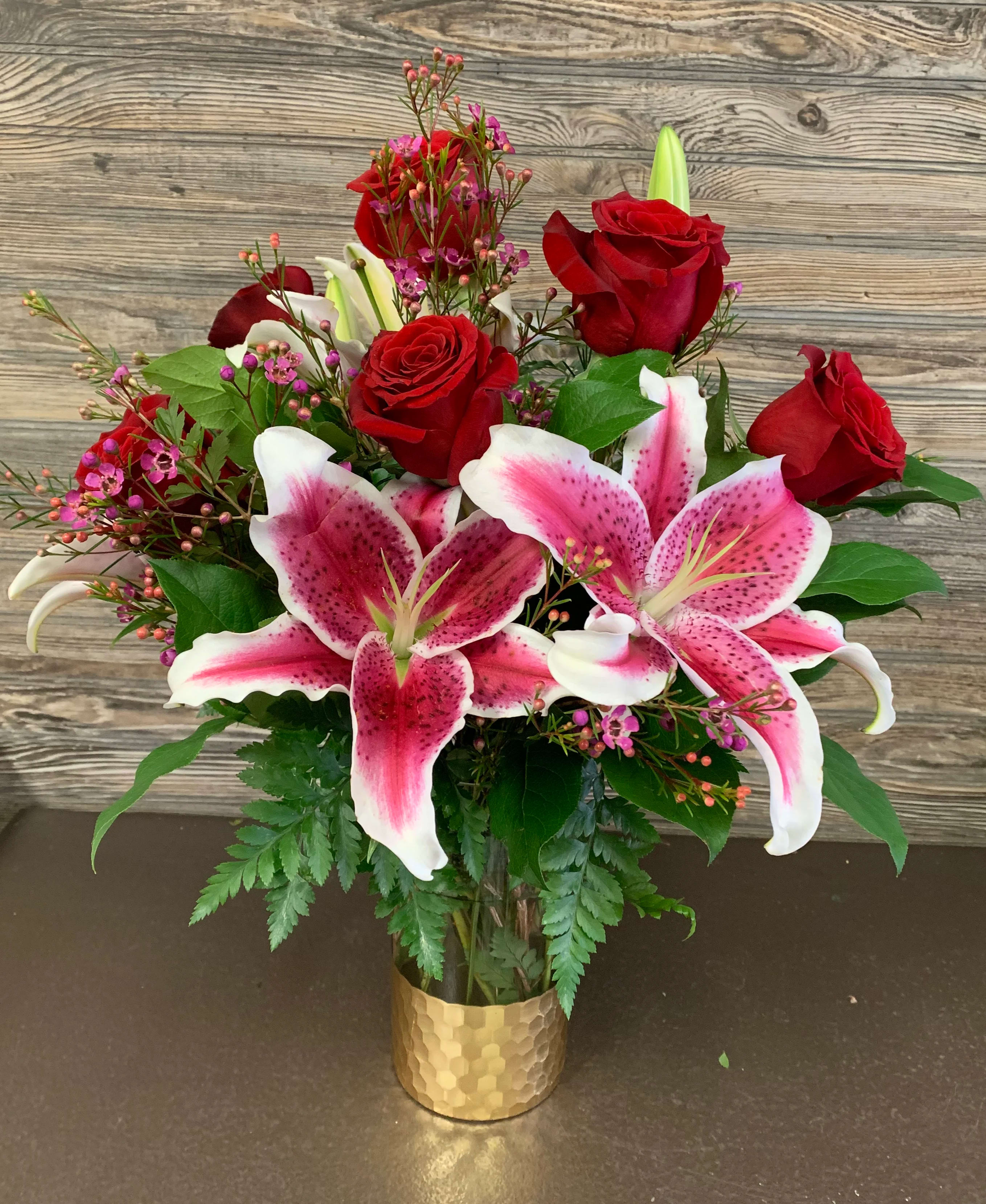 Adore You Bouquet  - Adore You Bouquet is a mixture of Pink Oriental Lilies and Red roses accented with greenery and wax flower in an really nice Accent Décor 9 inch clear glass Honeycombed bottom vase!  The vase is definitely a vase you will use again and again!  The arrangement designed is about 18hx 14w. 