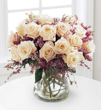 Monticello Rose Bouquet - The simple beauty of these white roses is accentuated by soft pink waxflower in a rounded bowl vase.  