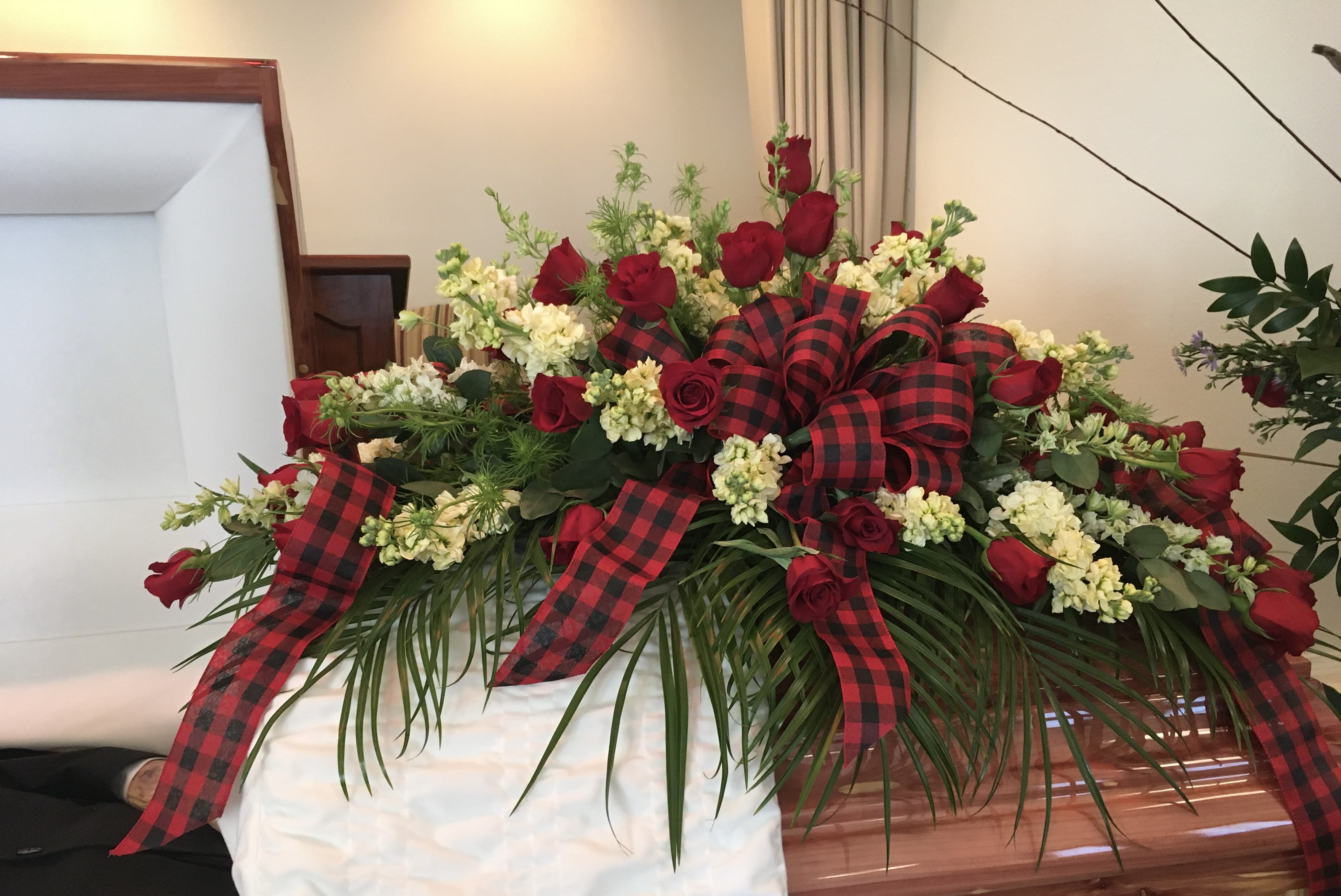 Buffalo Plaid Casket Spray - Red Roses, Stock, and Delphinium. This Casket Spray can be customized to fit your needs.