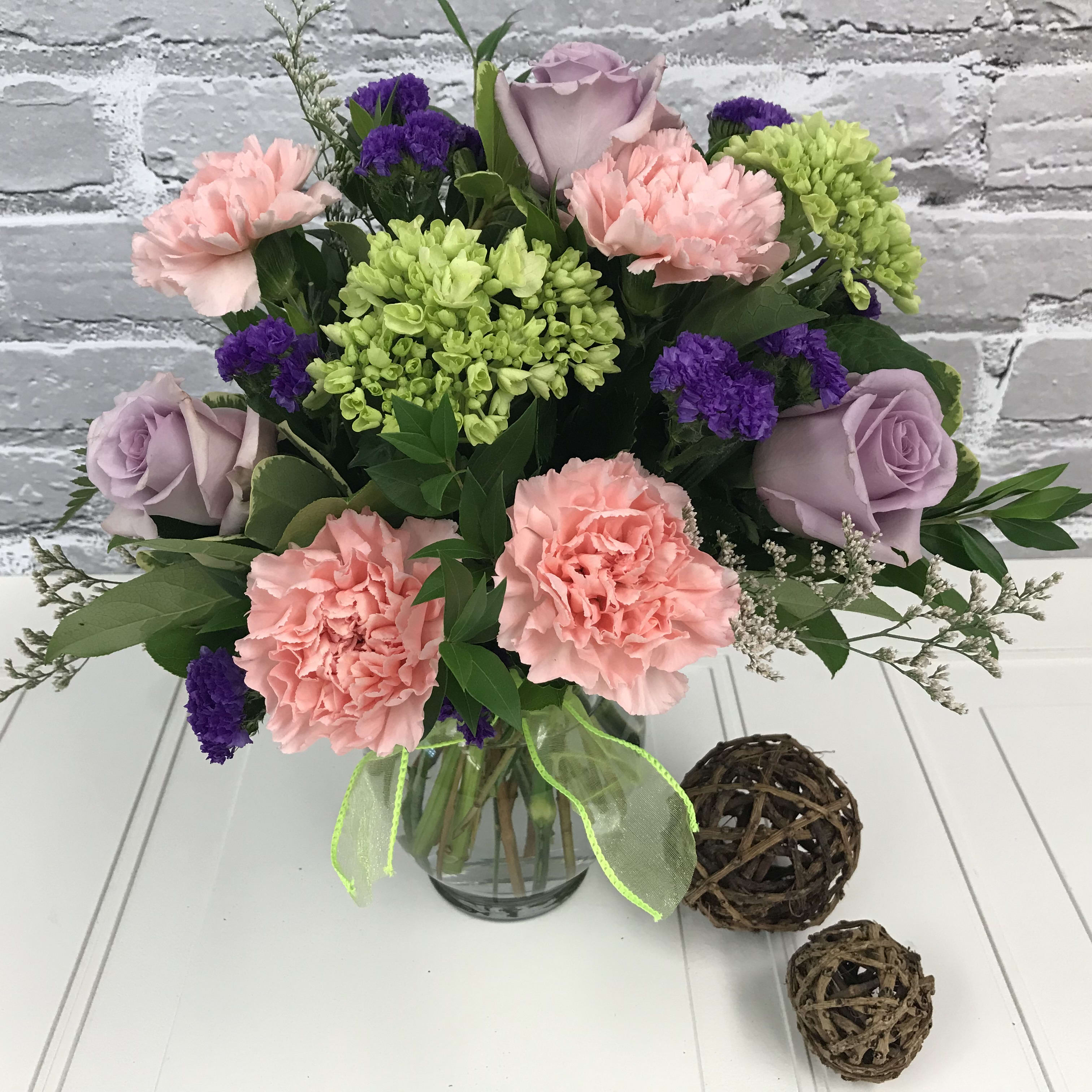 Perfect Pastels - Stunning lavender roses are combined with lush mini green hydrangeas and pink carnations to make this design pop! Who wouldn't love this bouquet? Perfect for any occasion.