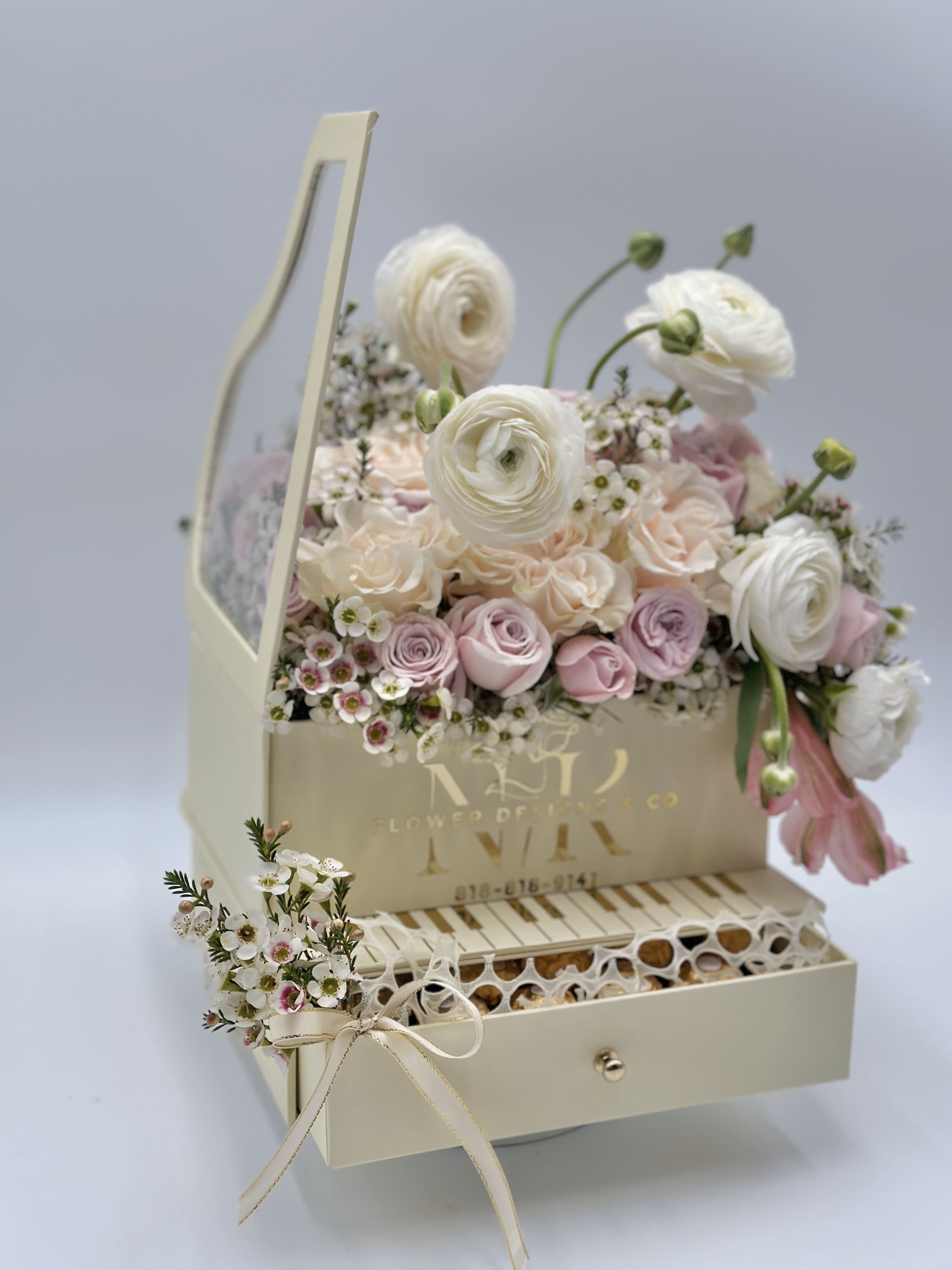 Spring Melody! - Ranunculus and Rose delicate combination for Spring! This piano box arrangement comes with a pull out drawer filled with chocolates!