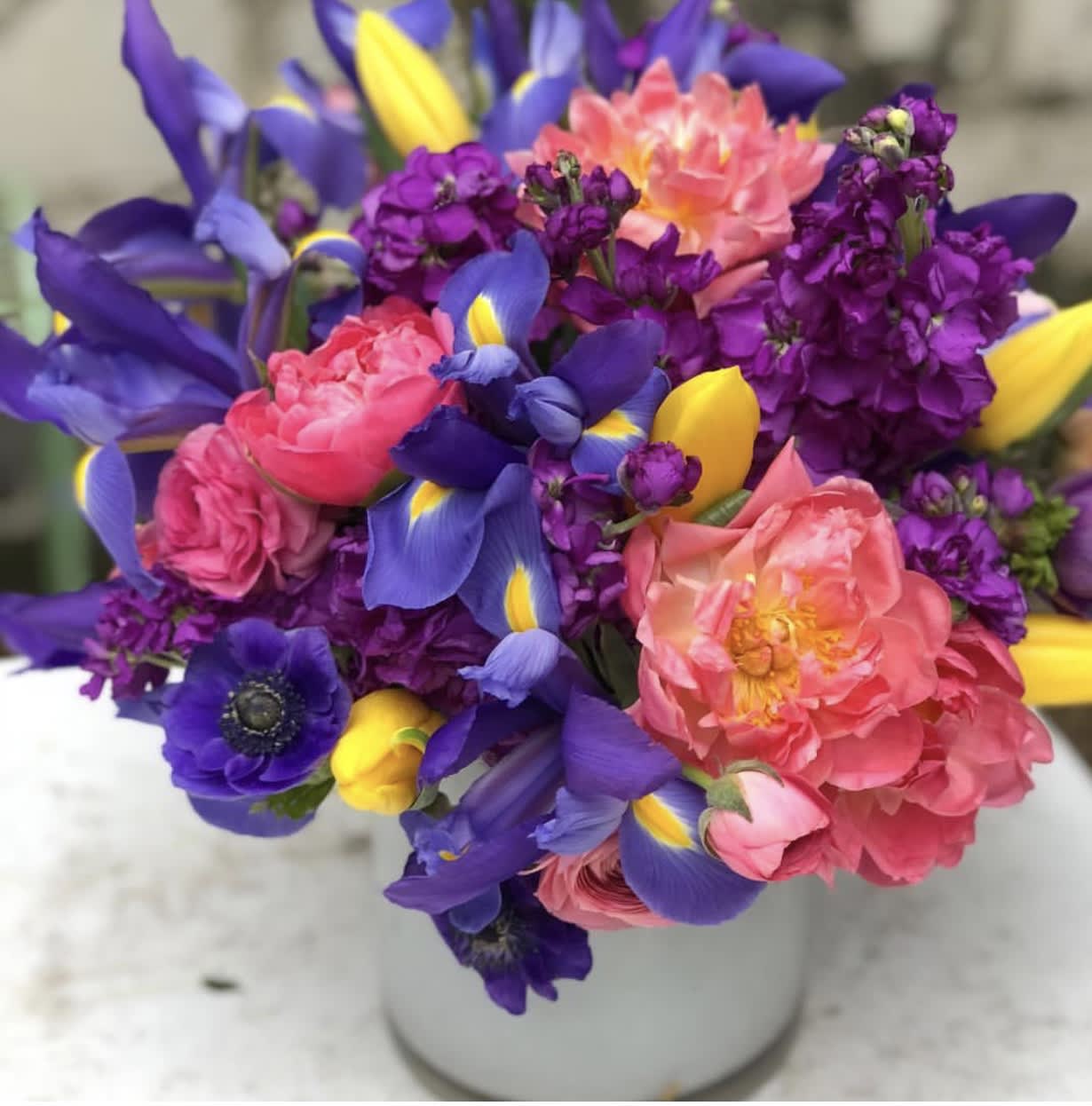 Bold & Bright Bold & Bright - This compact arrangement boast incredible colors and shapes with a tightly shaped modern design, free from greenery and fillers, the blooms really are the stars of this show.