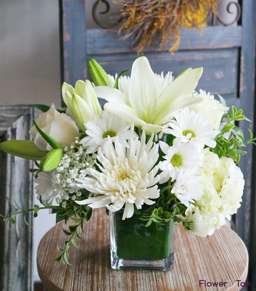 Serenity Bouquet - This all white arrangement of white lilies, chrysanthemums, daisies, roses and hydrangea is one simple beauty! Not too overwhelming, yet enough to let the recipient know they're being thought of. 