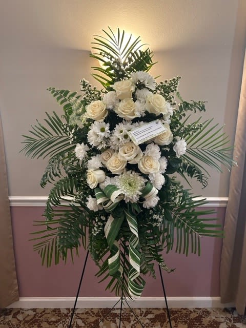 Ivory and Emerald standing spray Ivory and Emerald standing spray - Standing Funeral Spray filled with ivory, white and green blooms adored with a bow and an assortment of foliage price included sturdy coated metal aisle