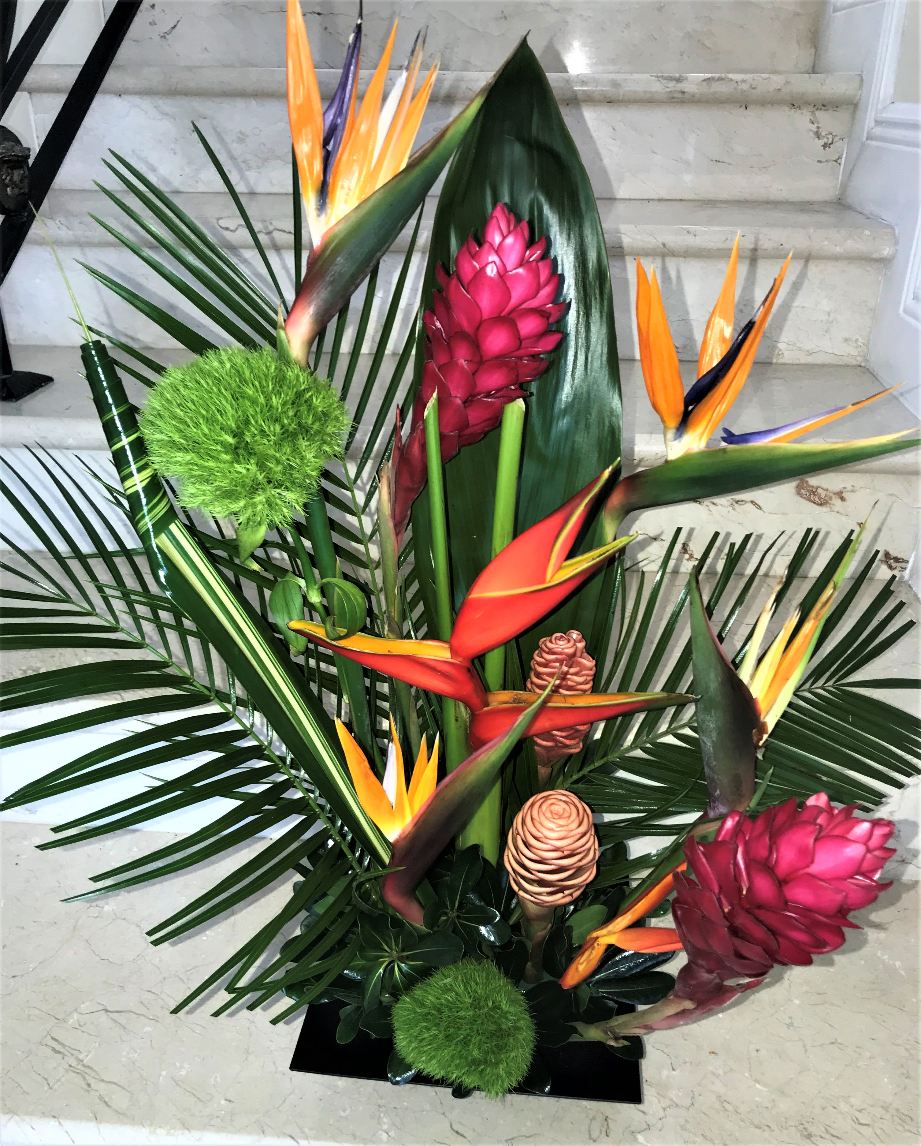 Tropical Sensation - Tropical arrangement arranged in a vase. Deluxe has more tropical flowers and greens than shown. Premium had much more tropical flowers and greens.