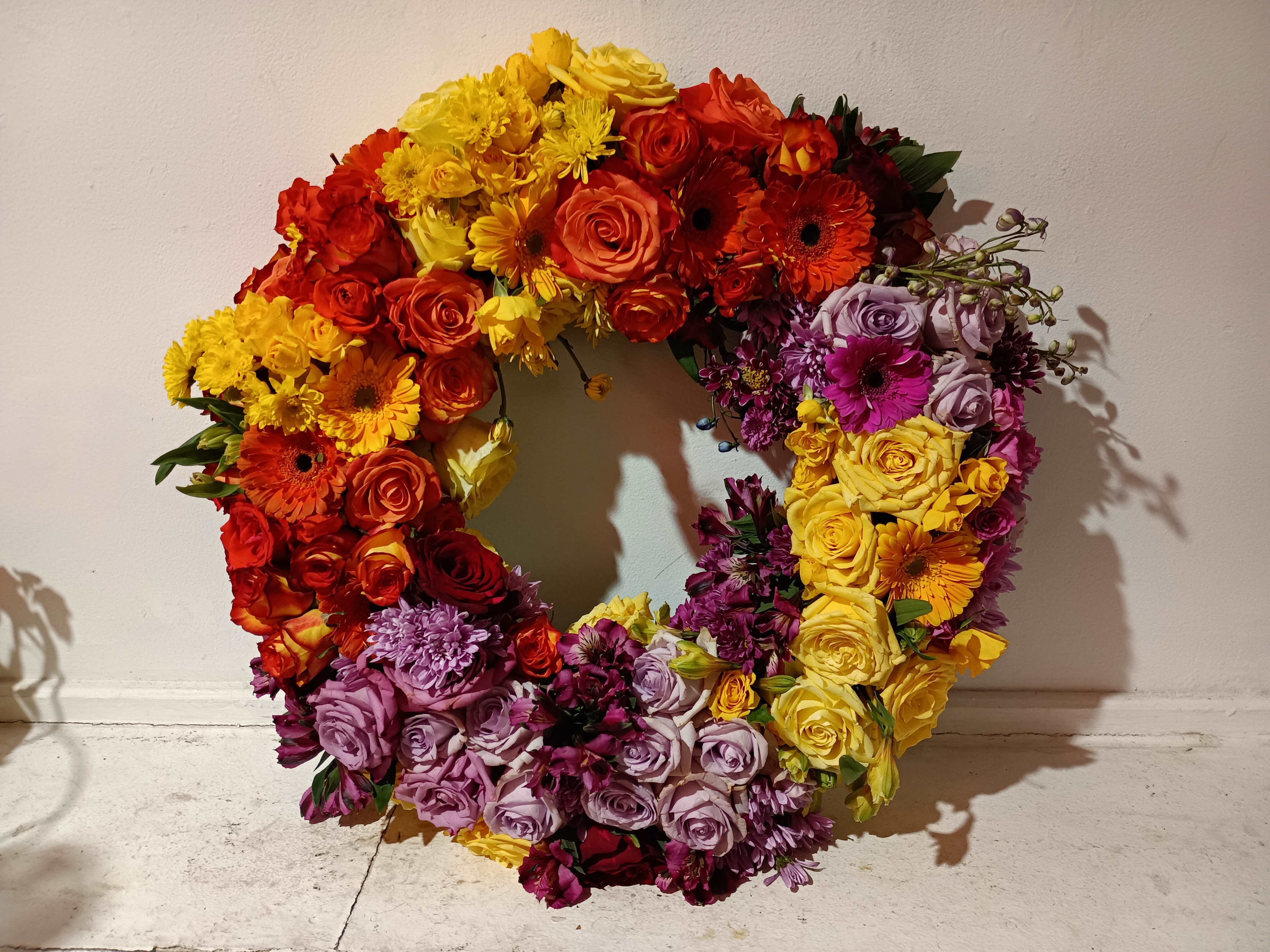 Sunset sorrow - Beautiful bright colors of yellow, orange, burgundy and purple with roses, gerbera daisies, daisies and alstroemeria mixed round standing vrith 