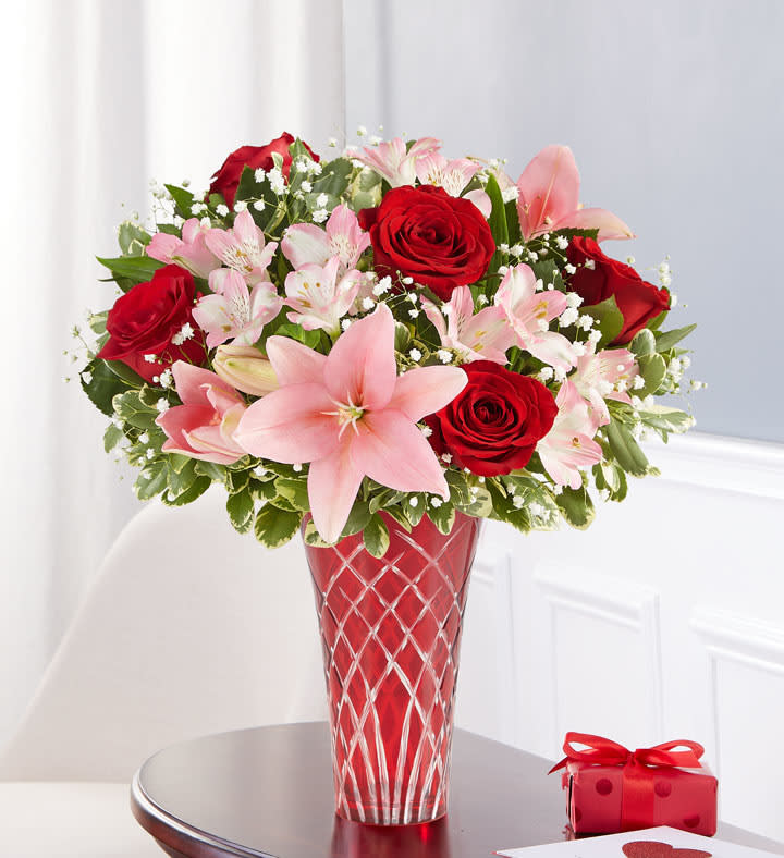 Key to My Heart - Red roses, pink lilies, pink alstro, and baby's breath arranged in a red radiant glass vase.  