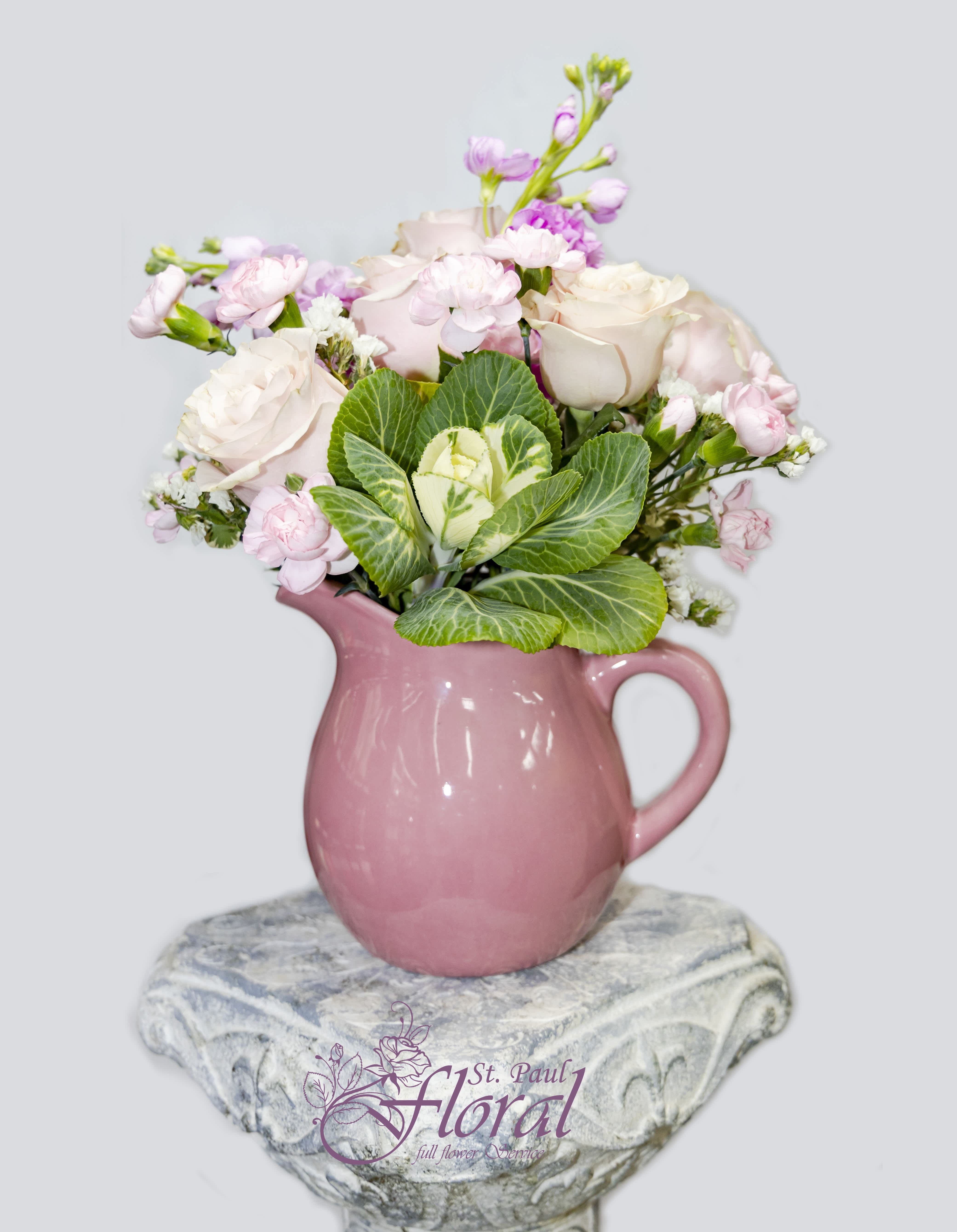 Spring Pitcher - This Spring Pitcher arrangement is the perfect gift for Spring. The light pastel shades of Roses, Stock, Mini Carnations and green flowering Kale will remind you that planting season is upon us. 