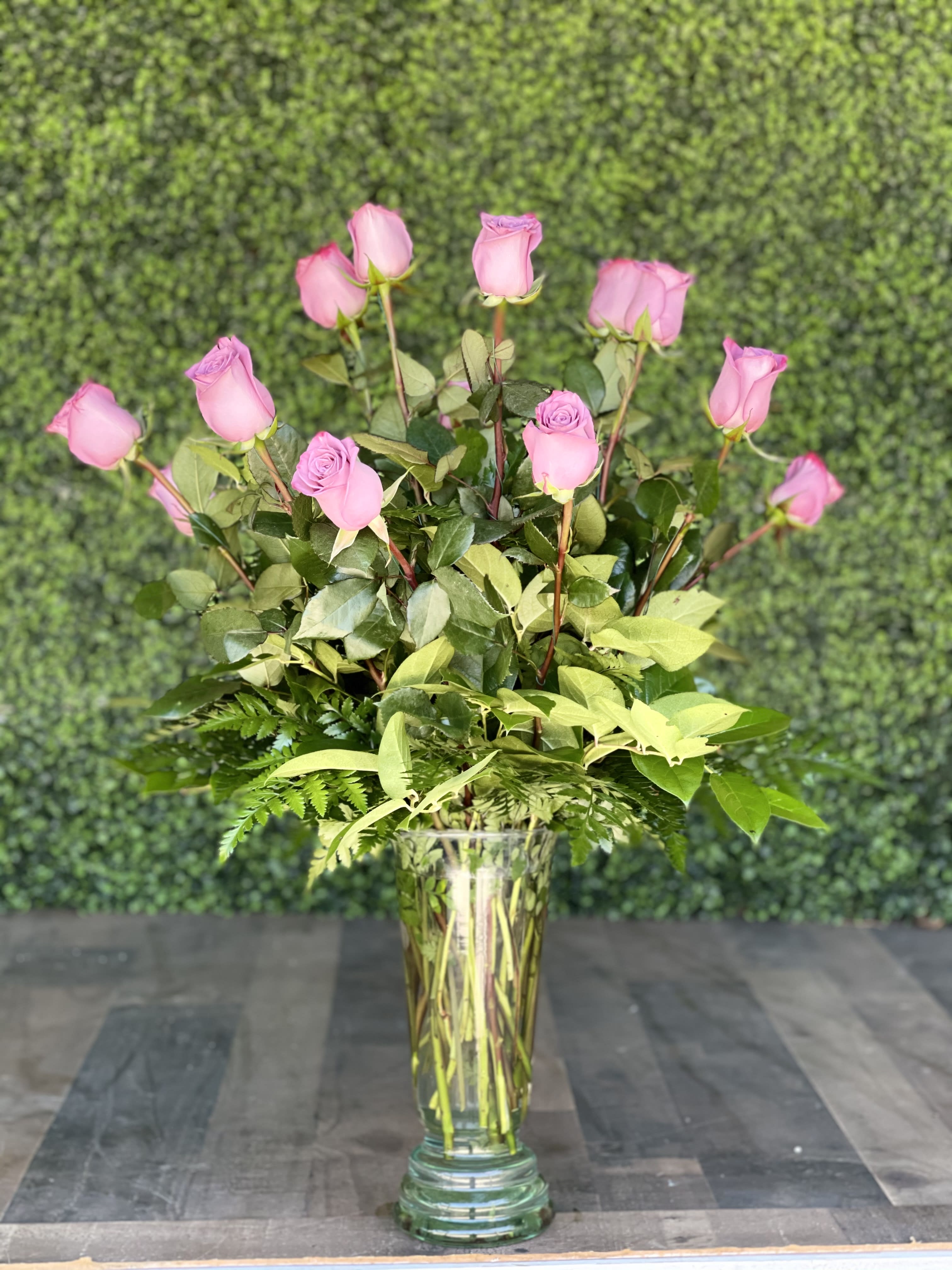 LAVENDER ROSES - A lavender rose arrangement designed in an updated glass vase with greens