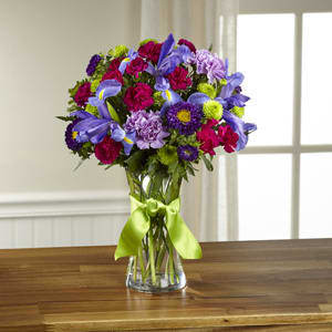 The FTD® Share My World™ Bouquet -  Share a world blooming in brilliant color and undeniable texture with this frilly and fun fresh flower bouquet . Blue iris, burgundy mini carnations, green button poms, lavender carnations, purple matsumoto asters, lavender roses, and lush greens mingle together to create a fascinating display. Presented in a modern clear glass vase tied with a lime green satin ribbon at the neck, this gift of flowers is a special surprise your recipient will love. GOOD bouquet includes 11 stems. Approx. 15&quot;H x 12&quot;W. BETTER bouquet includes 14 stems. Approx. 17&quot;H x 12&quot;W. BEST bouquet includes 18 stems. Approx. 18&quot;H x 13&quot;W. 