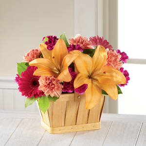 The FTD® Happiness™ Bouquet - Shine a light and send happy wishes to your recipient today, captured in each sunlit bloom of this simply beautiful flower bouquet. Bi-colored yellow and orange roses mingle with peach Asiatic Lilies, hot pink gerbera daisies, orange carnations, purple mini carnations, and lush greens arranged to perfection in a rectangular woodchip basket to create a truly cheerful moment. A great way to say happy birthday, get well, or thank you! GOOD bouquet includes 11 stems. Approx. 9&quot;H x 10&quot;W. BETTER bouquet includes 15 stems. Approx. 10&quot;H x 11&quot;W. BEST bouquet includes 18 stems. Approx. 11&quot;H x 13&quot;W. 