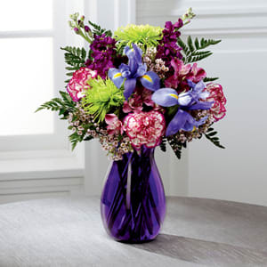 The FTD® Gratitude Grows™ Bouquet -  Blooming with rich color and undeniable texture, this stunning bouquet expresses love and gratitude with each perfect flower. Blue Iris, fragrant purple gilly flower, purple Peruvian Lilies, purple bi-color carnations, green spider chrysanthemums, clusters of pink wax flower, and lush greens create a fascinating display presented in a deep purple glass vase with modern lines to create a sophisticated look. A wonderful thank you or thinking of you gift! GOOD bouquet includes 12 stems. Approx. 20&quot;H x 15&quot;W. BETTER bouquet includes 16 stems. Approx. 20&quot;H x 15&quot;W. BEST bouquet includes 21 stems. Approx. 21&quot;h x 16&quot;W. 