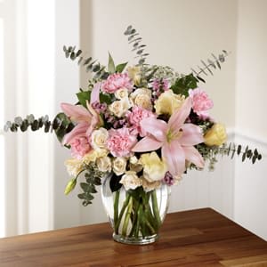 The FTD® Classic Beauty™ Bouquet -  Soft, feminine, and blooming with a flowering finesse at every turn, this gorgeous fresh flower arrangement has a classic elegance to it that simply never goes out of style. Pink Asiatic Lilies serve as a focal point to this flower bouquet surrounded by cream double lisianthus, pink carnations, white spray roses, pink statice, and pink roses, lovingly accented with fronds of Queen Anne's Lace, stems of baby blue eucalyptus, and lush greens. Presented in a classic clear glass vase, this gorgeous gift of flowers is arranged just for you to create a treasured moment in honor of your recipient's birthday, an anniversary, or to celebrate the birth of a new baby girl. GOOD bouquet includes 12 stems. Approx. 16&quot;H x 18&quot;W. BETTER bouquet includes 14 stems. Approx. 17&quot;H x 19&quot;W. BEST bouquet includes 19 stems. Approx. 19&quot;H x 21&quot;W. 