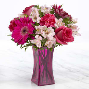  The FTD® Truly Stunning™ Bouquet B54 -  The FTD® Raspberry Rush™ Bouquet blushes with incredible color to send bright beauty and bold style straight to your special recipient today! Set to capture their every attention, this fresh flower arrangement brings together hot pink roses, hot pink gerbera daisies, and hot pink carnations with pops of soft pink Peruvian Lilies and lush greens to create a bouquet that is simply unforgettable. Presented in a modern hot pink glass vase to give it a fully finished look, this flower bouquet is ready to create an incredible birthday, thank you, or thinking of you gift. GOOD bouquet is approximately 14&quot;H x 12'W. BETTER bouquet is approximately 14&quot;H x 13&quot;W. BEST bouquet is approximately 15&quot;H x 14&quot;W. 