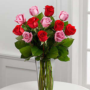 The FTD® True Romance™ Rose Bouquet -  The FTD® True Romance™ Rose Bouquet is the perfect expression of love and passion to make this a truly memorable Valentine's Day. A bright burst of color, this bouquet combines red, pink and fuchsia roses, accented with beautiful greens and seated in a clear glass vase, to create a truly romantic representation of your love. 