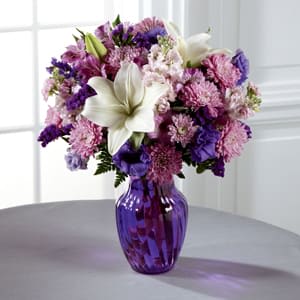 The FTD® Shades of Purple™ Bouquet -  Everyone loves a little purple in their life - it's elegance, it's twilight magic, it's expression of the unexpected. Send your recipient every shade of purple nature can supply with this flower arrangement, bringing together lavender gilly flower, purple double lisianthus, lavender chrysanthemums, purple Peruvian Lilies, and purple statice, accented with white Asiatic Lilies and lush greens presented in a modern purple swirled glass vase. A wonderful birthday, anniversary, or thank you gift! GOOD bouquet includes 12 stems. Approx. 16&quot;H x 13&quot;W. BETTER bouquet includes 15 stems. Approx. 17&quot;H x 14&quot;W. BEST bouquet includes 18 stems. Approx. 18&quot;H x 15&quot;W. 
