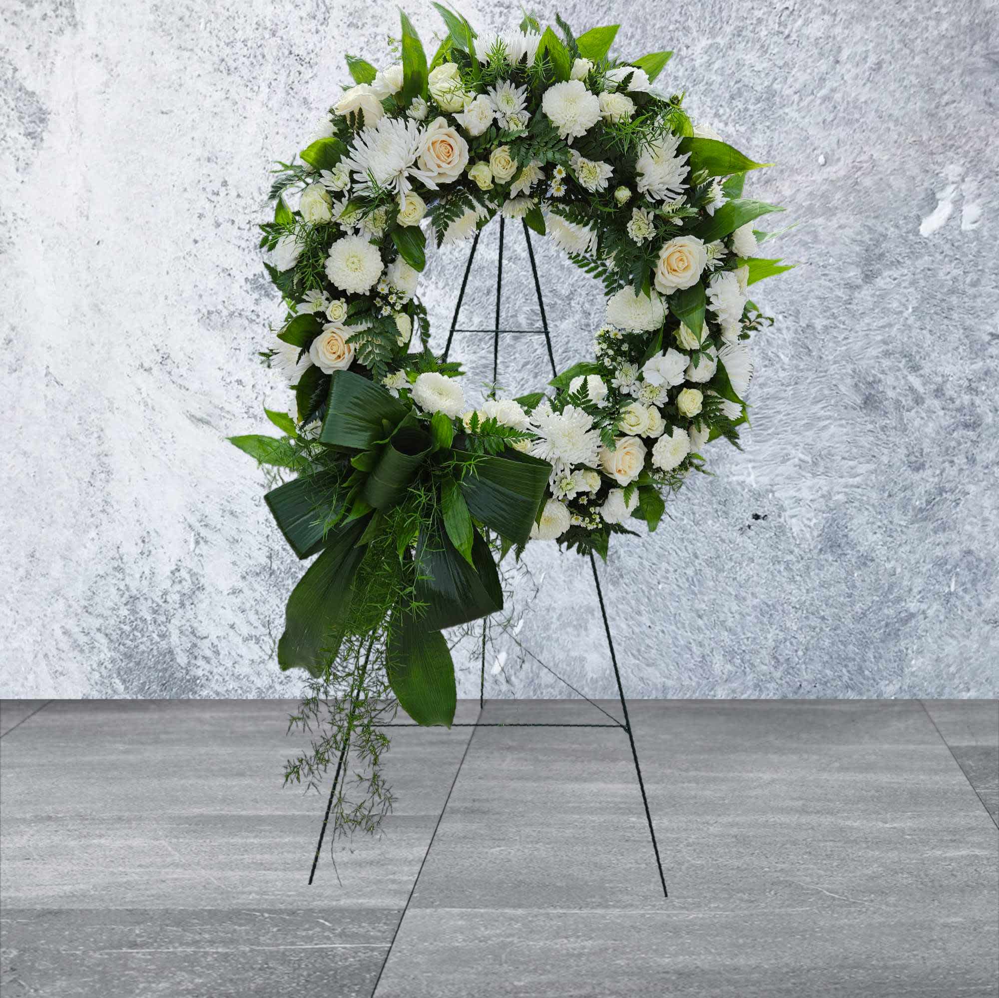 Peaceful Farewell Peaceful Farewell - This wreath is a perfect way to say farewell to a friend or loved one. An 18inch round wreath covered in greenery and white blooms with a naturally made leaf bow.