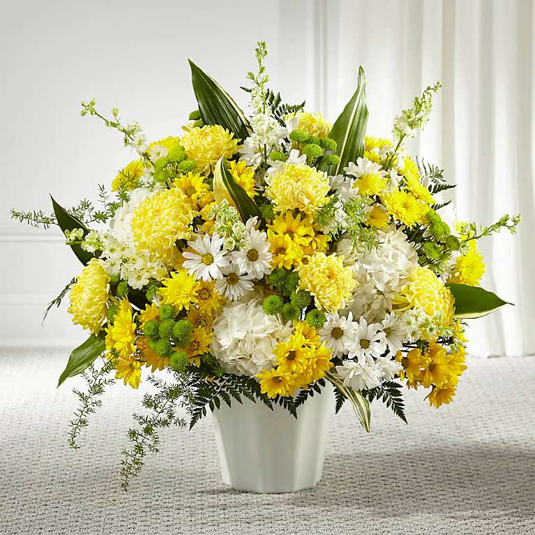 Unity &amp; Grace Floor Basket - Every bloom in our Unity &amp; Grace™ Floor Basket reminds us of the brightness of their spirit. This stunning arrangement features an uplifting mix of hydrangea, larkspur, daisy pompons and mums. Each arrangement is handcrafted and hand delivered by a local florist, making it a touching gesture for loved ones.