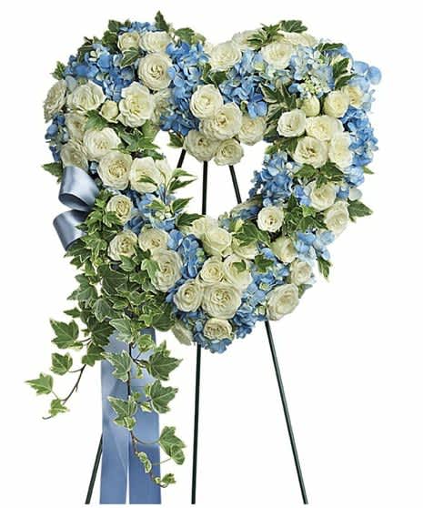 Pure Heart  - Offer comfort and tranquility with a truly special display..This heartfelt arrangement features blue hydrangea, white spray roses, and variegated ivy. Delivered on a wire easel