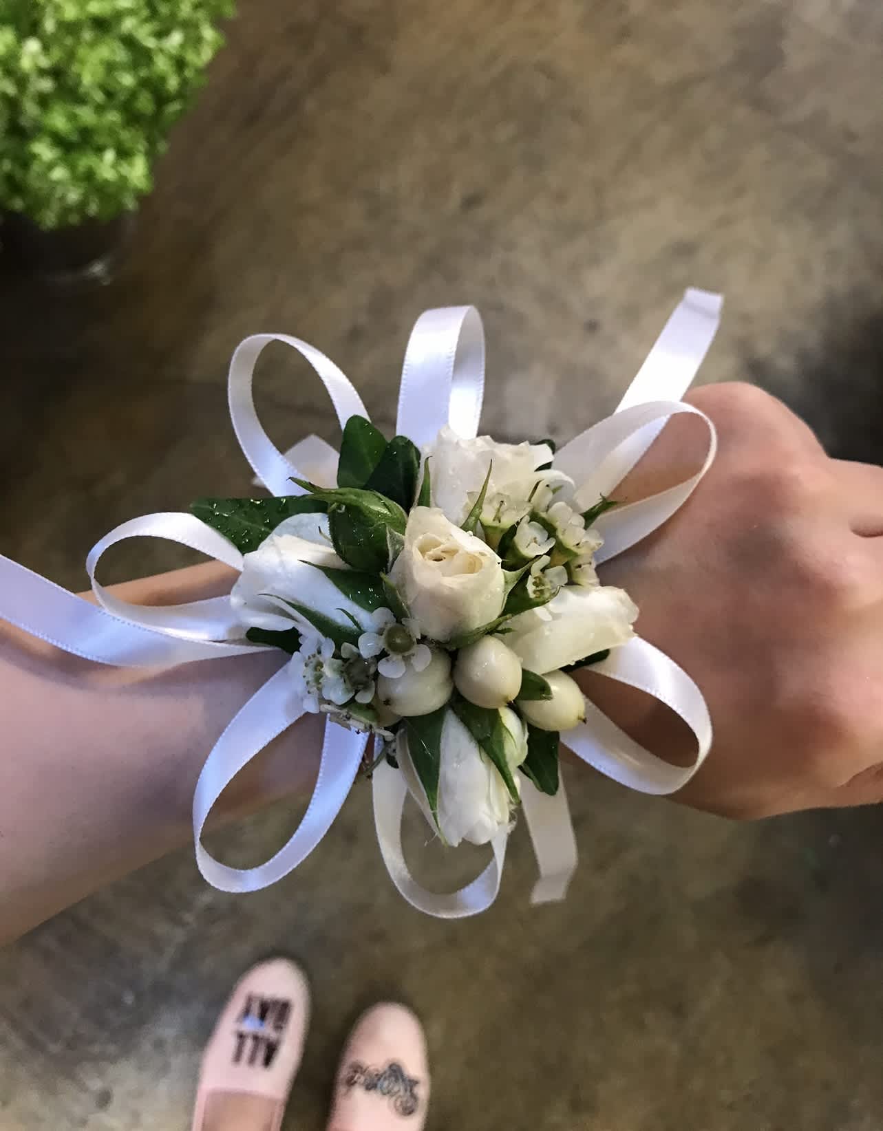 White corsage  - A classic white rose and white coffee bean corsage compliments any outfit.  Perfect for prom, formal, and weddings. Substitution Policy In some instances, our photo may