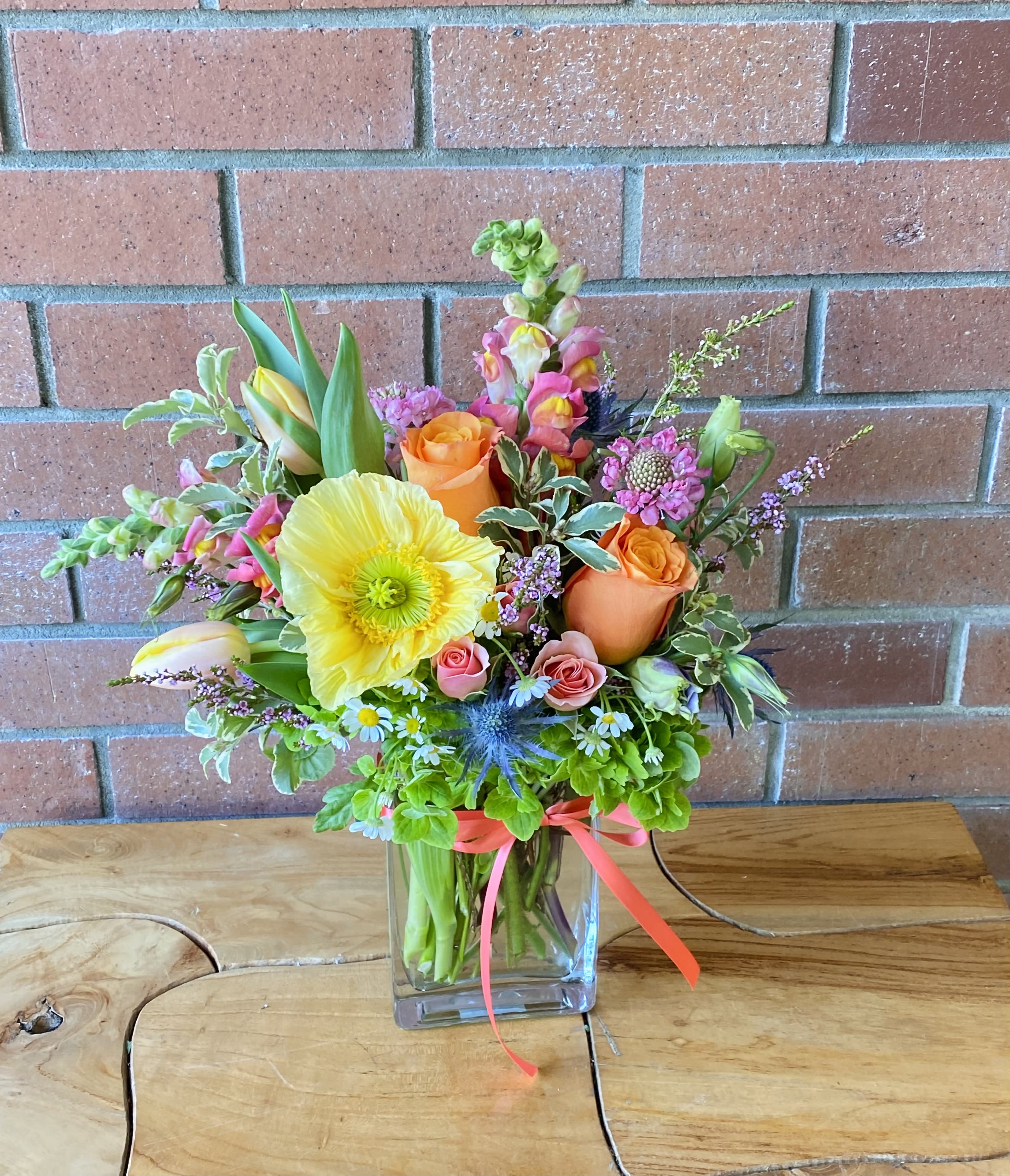 Summer Glow Summer Glow - Green hydrangeas, coral garden roses, spray roses, tulips, snapdragons, poppies, premium greens and fillers designed in a pretty rectangular clear vase.
