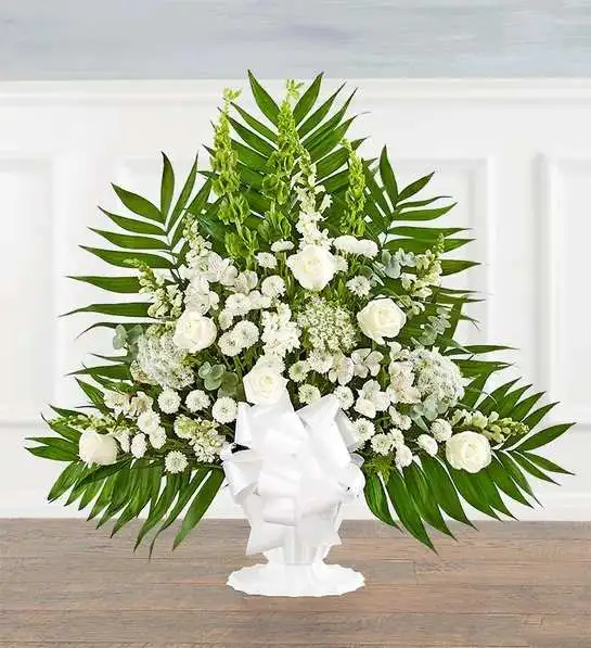 Tranquility Basket All White Tranquility Basket All White - Offer comfort and tranquility with a truly special display. Our floor basket arrangement is a unique addition to the services, standing over three feet high with lush greenery that cascades out for an elegant presentation. This stylish design is gathered with a flourish of white blooms, creating a beautiful tribute to celebrate their life.Floor basket arrangement with white roses, snapdragons, Peruvian lilies (alstroemeria), Queen Anne’s lace, button poms and stock, green Bells of Ireland; accented with spiral eucalyptus, assorted