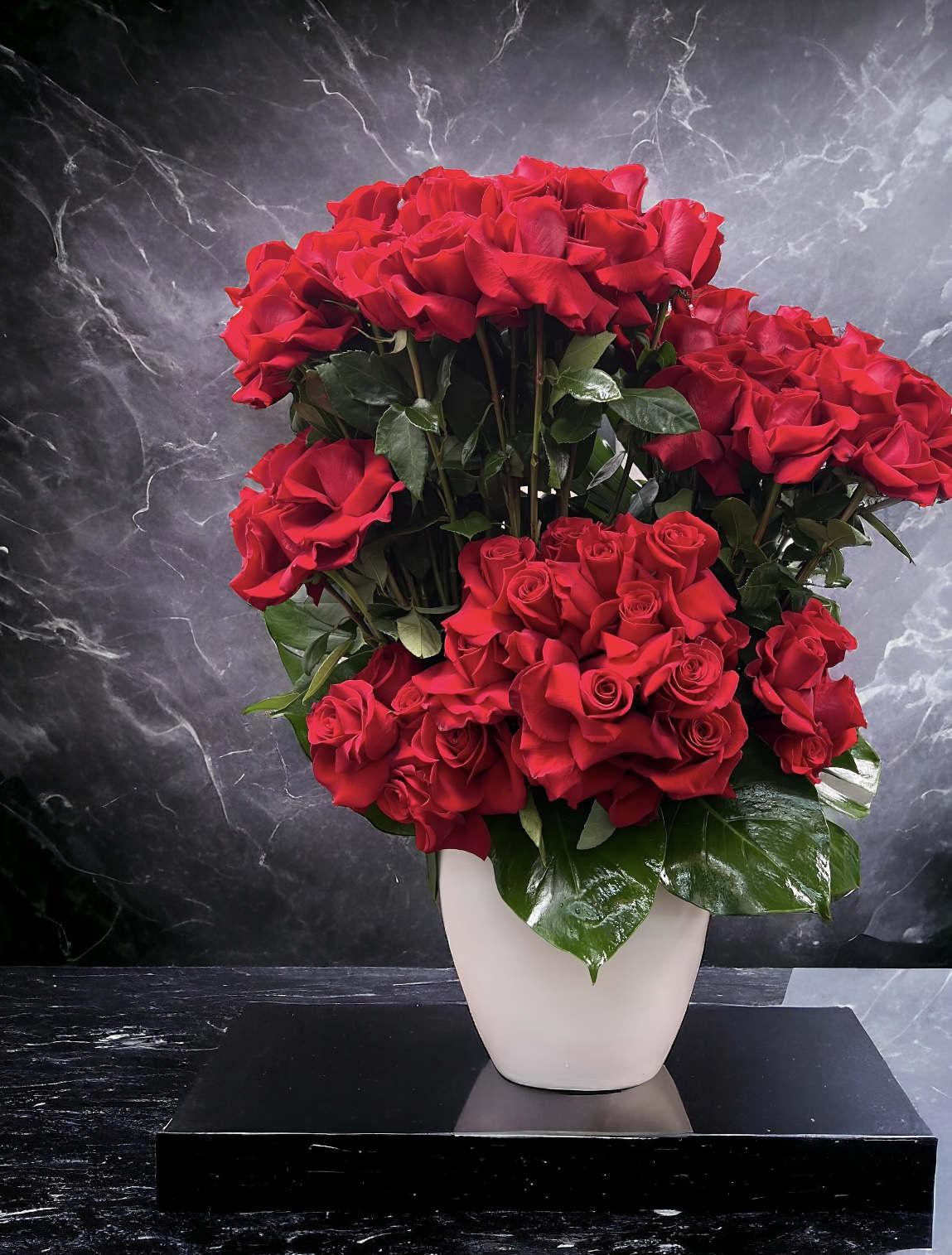 Rose Lover Rose Lover - A bursting field of 75 red roses! This arrangement sits at a grand 35 inches tall and 20 inches wide in a contemporary white ceramic vase.