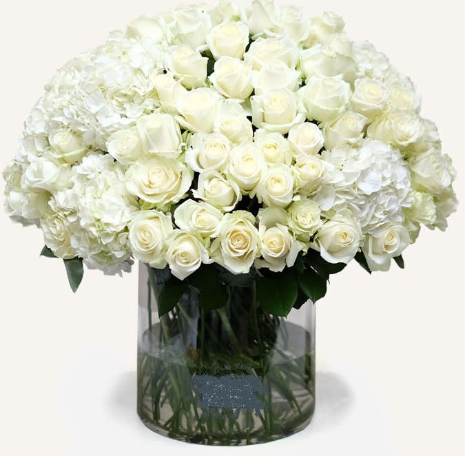      Pure Love Bouquet - For something a little different, treat the one you love to this beautiful bouquet in purest white. Whether you’re sending someone a romantic gift or expressing condolences, this understated bouquet is the way to do it. We’ve paired dazzling white fresh hydrangeas and roses in a clear cylinder vase.. Simple yet perfect. 