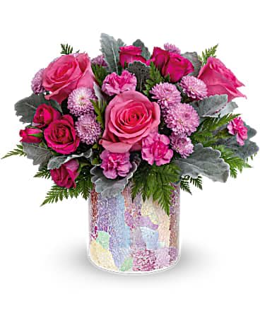 Radiantly Rosy Bouquet - Give any occasion a rosy glow with this radiant rose bouquet! Arranged in an iridescent mosaic glass vase, it's a gift they'll never forget. This arrangement features pink roses, hot pink spray roses, miniature pink carnations, lavender button spray chrysanthemums, dusty miller and leatherleaf fern. Delivered in a Radiantly Rosy cylinder.  