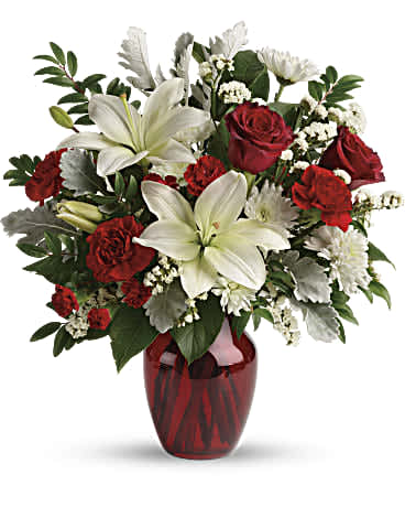 Visions of Love Bouquet  - Give your special someone visions of love with this luxurious gift of bright white lilies and romantic red roses, presented in a radiant red vase. This beloved bouquet includes red roses, white asiatic lilies, red carnations, red miniature carnations, white cushion spray roses, white sinuata statice, dusty miller, huckleberry, and lemon leaf. Delivered in a ruby rose vase. Orientation: All-Around  SUBSTITUTION POLICY – Always deliver the freshest flowers! Please note the bouquet pictured reflects our original design.  If the exact flowers or container in this arrangement are not available, our local florists will create a beautiful bouquet with the freshest available flowers.