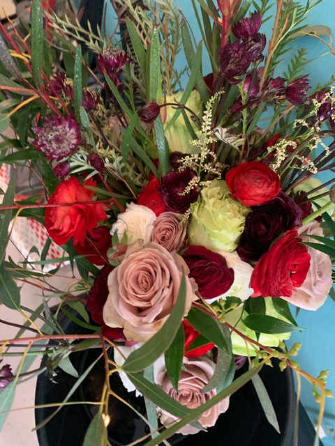the &quot;Susan&quot; - This striking bouquet is filled with drama and color. The deeply romantic red tones play beautifully with the dark foliage, creating a full and gorgeous collection that would make anyone swoon.