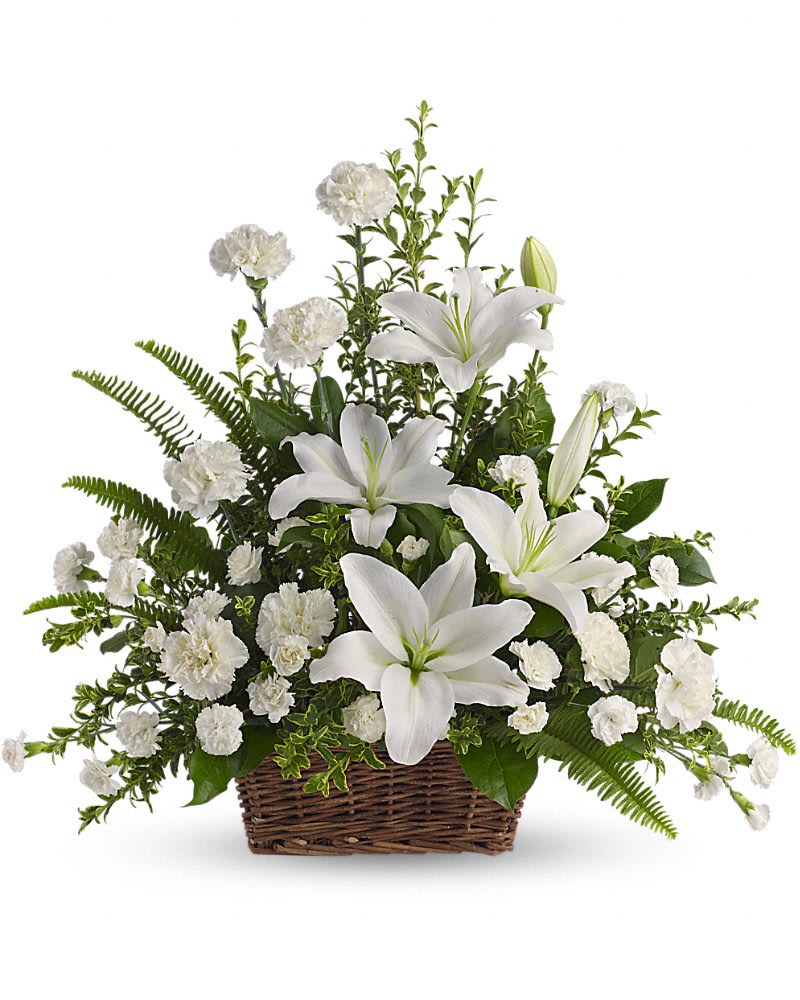 Peaceful White Lilies Basket - Whether you send this beautiful arrangement to the family home or to the service all will appreciate its elegance and grace. The contrast of brilliant white blossoms and dazzling greenery create a wonderfully calm and dignified setting. Gorgeous flowers such as white lilies carnations and miniature carnations mix with vibrant greens in a large basket. Simply stunning.