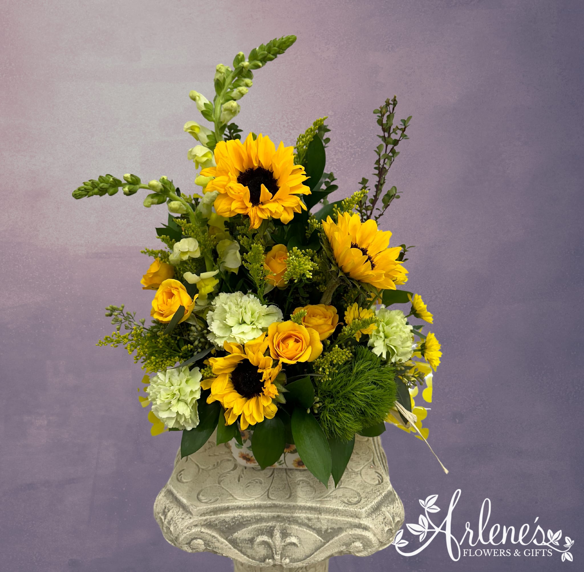 Sunny Side Up! - Sunflowers, carnations, spray roses. This yellow and green arrangement is a little Green Eggs and Ham...the container can be used to cook something up...