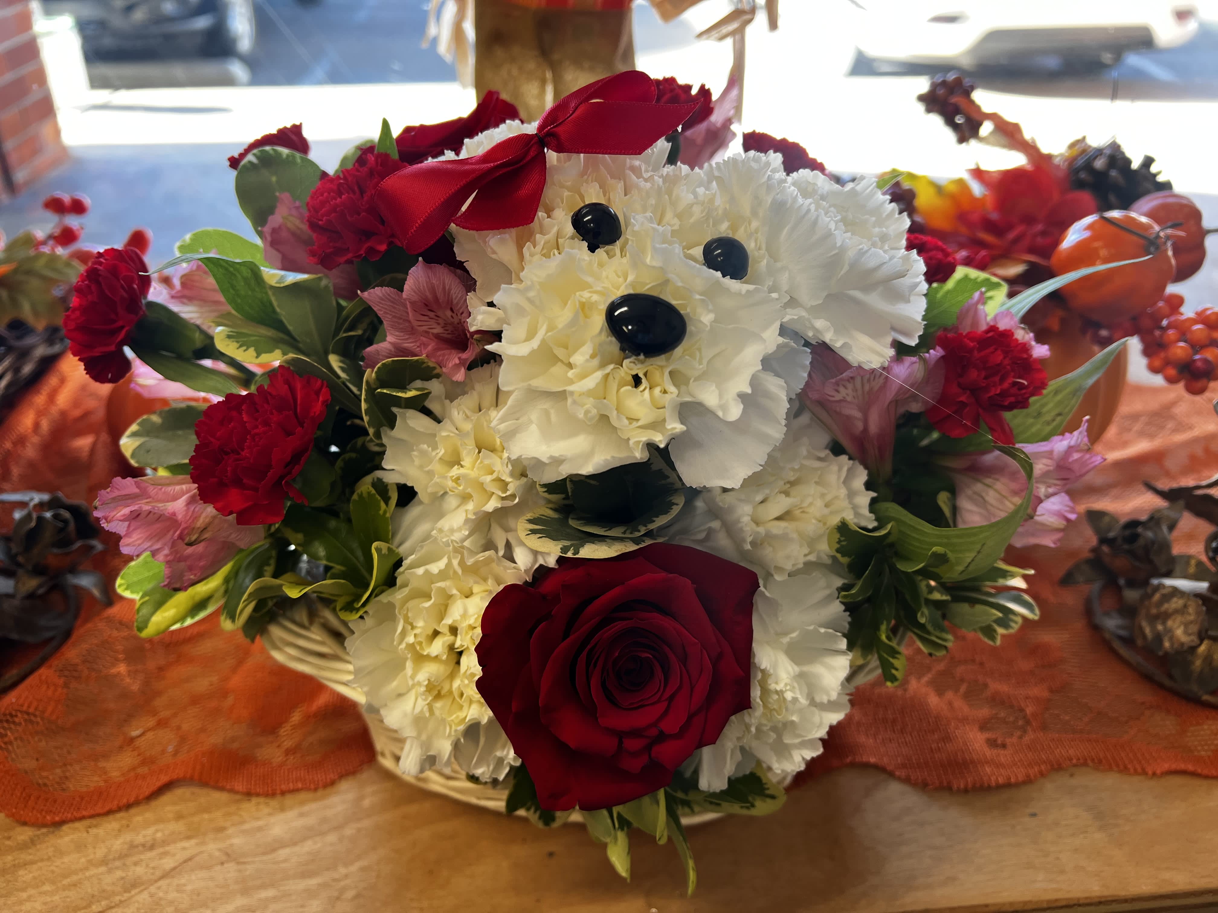 Puppy Love - A cute Puppy with White carnations and a red rose.