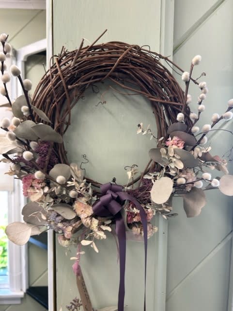 Grapevine Wreath  - This grapevine wreath has dried statice, seeded eucalyptus and pussy willow. A dark purple satin ribbon gives this wreath a dramatic touch. 