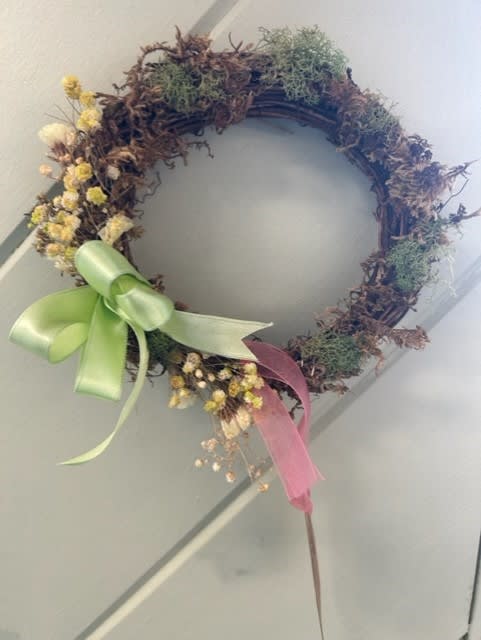 Small Willow Wreath - This adorable willow wreath features dried moss, dried and dyed yellow babies breath, yellow dried statice and a light green double faced satin bow. 