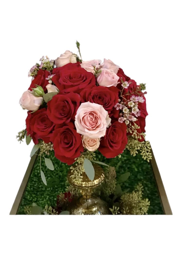Lovely day Lovely day - Take in the royal beauty of the red rose with pink spray roses. this stunning floral arrangement. Up to 30 red roses with pink wax flower and seed eucalyptus leaves providing the perfect accent. Resting inside of a 7 inch tall gold vase, this arrangement stands at approximately 12” tall and 8” wide overall.