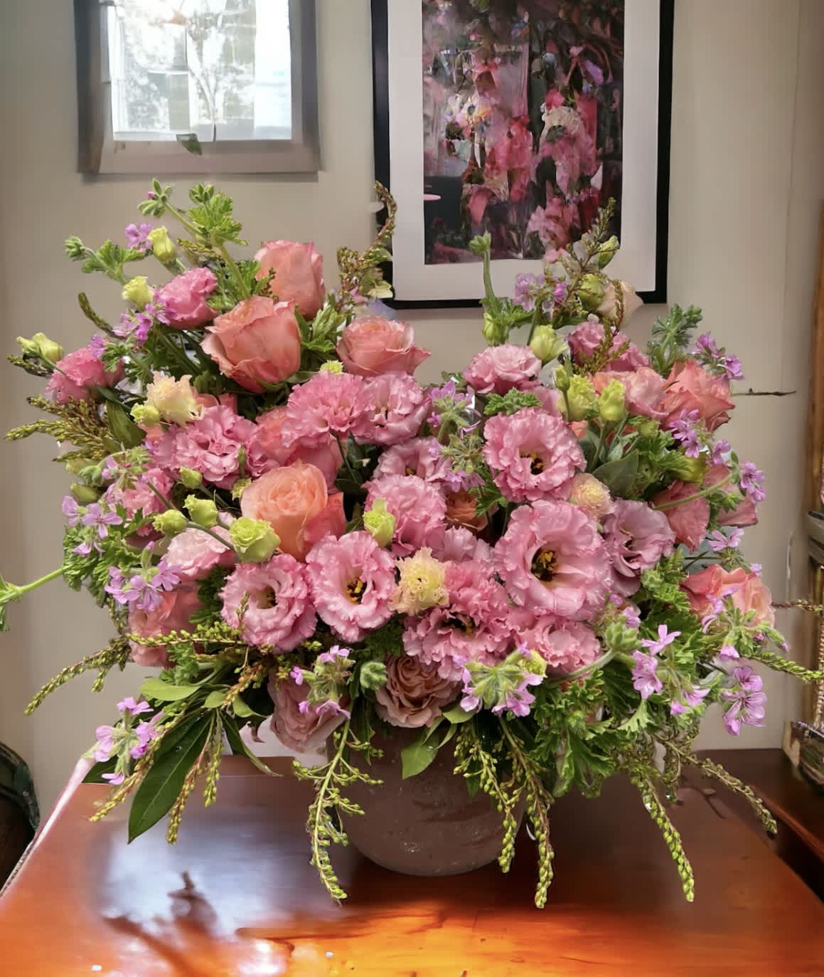 Pink fairy - Flower : Pink and peach roses with pink Lisianthus elegantly arranged in an asymmetrical masterpiece.  Vase : Spilling out of a 6&quot; tall clay, round pot 