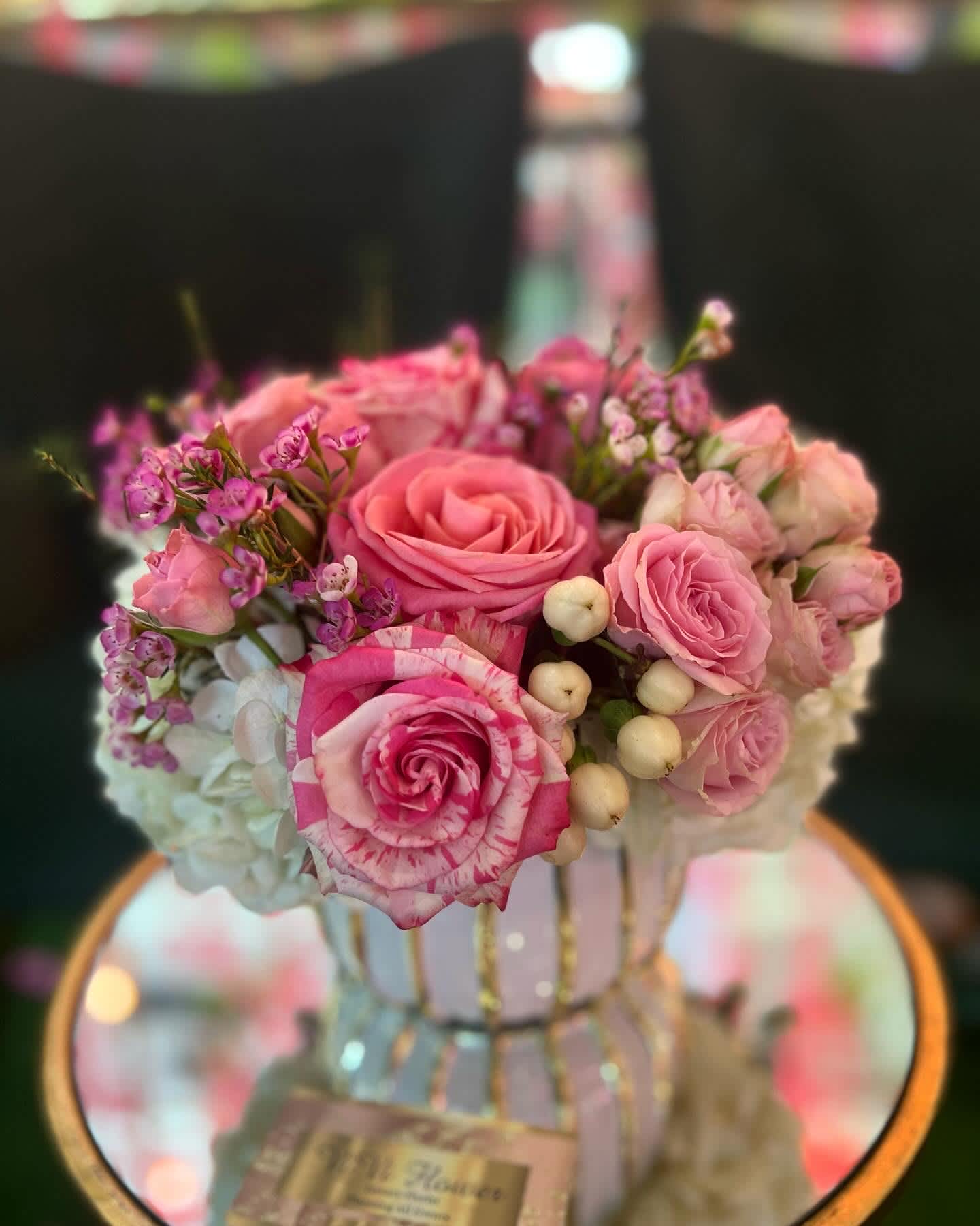 Love story  - Beautiful and dreamy arrangement with pink hydrangeas  pink roses, pink spray roses and a touch of wax flowers and coffee beans to bring the arrangement together. Textured white vase gold string measuring 5” by 5” inches in total 8” height and 8” inches in width.