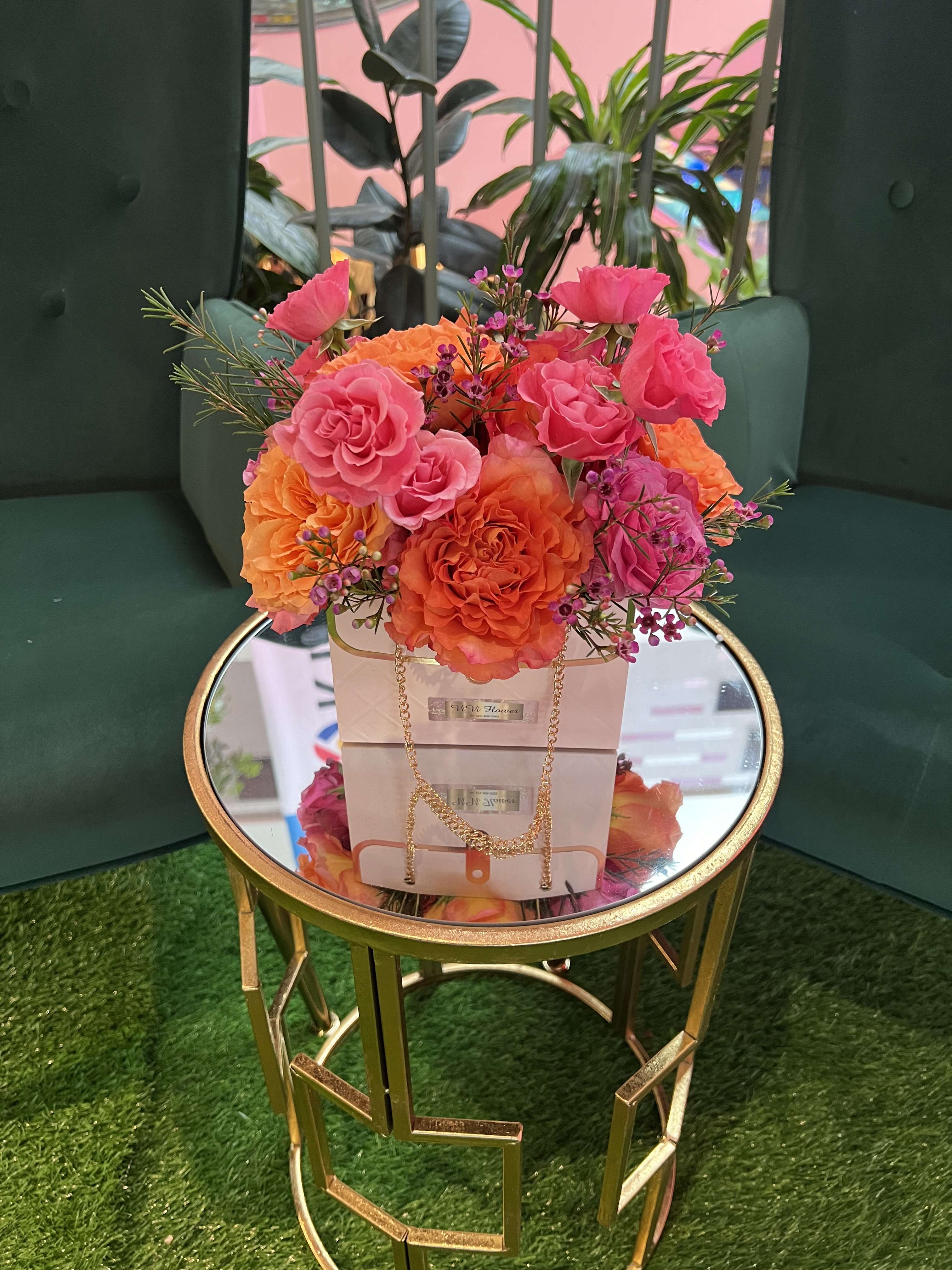 Pink cutie bag - Take in the royal beauty of the orange rose , pink spray roses with pink wax flower arrangement Resting inside of a H4 * W6 “ cute pink paper bag. 