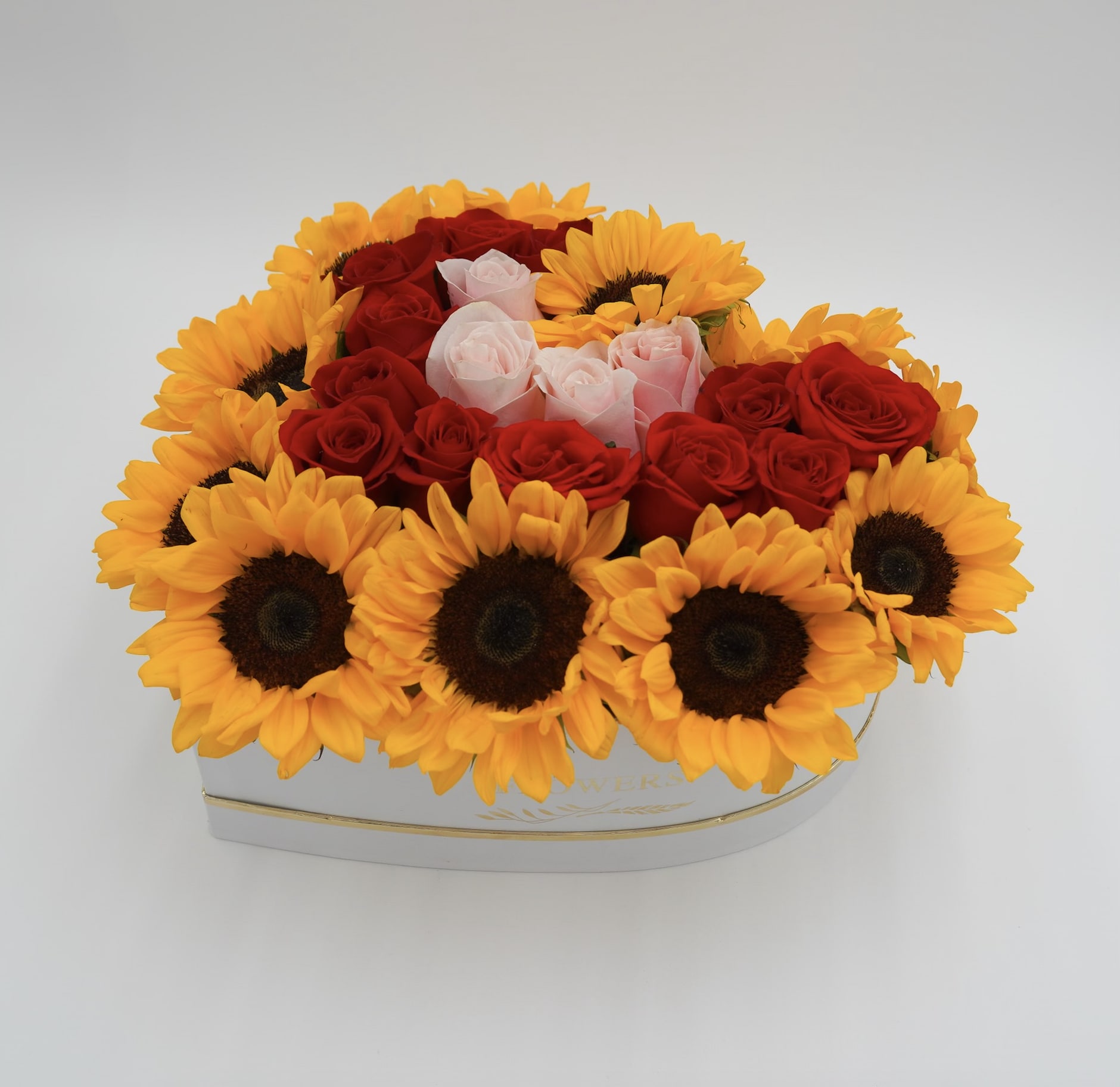 Radiant Sunburst - A masterpiece of nature's bounty. Each sunflower and rose carefully selected to ensure vibrant color and freshness. Let it's golden glow radiate your surroundings with warmth and positivity.