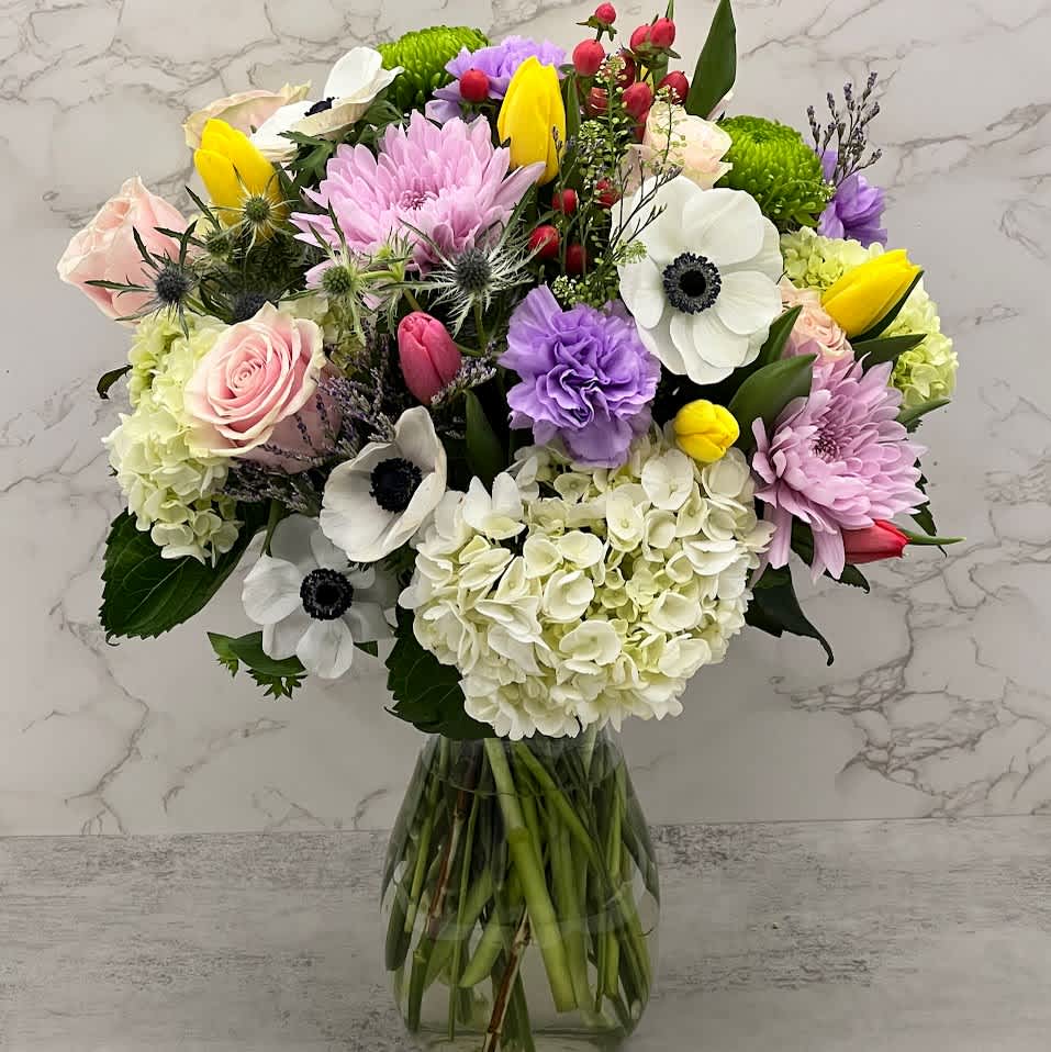 Spring Party  - A unique out of the ordinary mixed bouquet with soft and bright colors celebration the spring season with tulips, large fluffy hydrangeas, pops of light pink roses, pink cremon and luxury anemones and greenery to give this gorgeous bouquet some volume. 